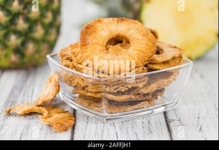 Pineapple rings (dried) on rustic wooden background as close-up shot Stock Photo