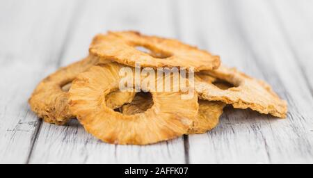 Pineapple rings (dried) on rustic wooden background as close-up shot Stock Photo