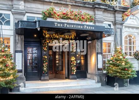 Exterior of, and entrance to, The Printing Press, a Bar and Kitchen in George Street in Edinburgh New Town. The entrance is decorated for Christmas wi Stock Photo