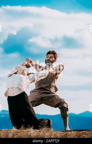 Two athletic young dancers making a performance at mountain peak Stock Photo