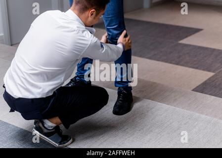 Security guard making a pat-down procedure for finding hidden objects on the person entering Stock Photo