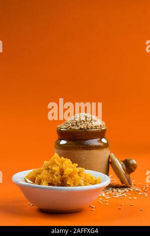 Sesame Seeds in clay pot with Jaggery in bowl Stock Photo