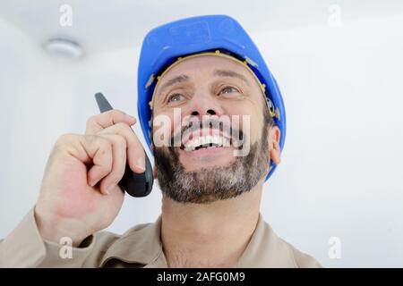 laughing builder using two way radio Stock Photo