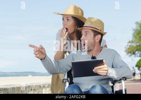 couple in wheelchair looking surprised at women Stock Photo
