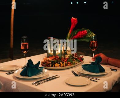 Set the table for dinner on the beach in Mui Ne Town, Phan Thiet, Vietnam. Stock Photo