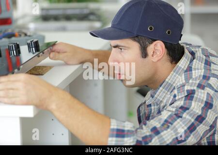 a man is installing kitchen Stock Photo