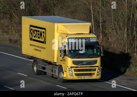 System3 yellow Haulage delivery trucks, lorry, transportation, truck, cargo carrier, Volvo vehicle, commercial transport industry, M6 at Lancaster, UK Stock Photo