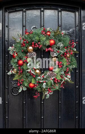 Christmas wreath on an old wooden black door in Stratford Upon Avon, Warwickshire, England Stock Photo