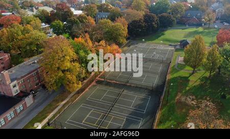 Playground and public park with trees in colourful autumn foliage in upscale residential area in Pennsylvania, classic northeast american suburban Stock Photo