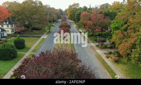 Tranquil alley in suburban area of Lancaster, Pennsylvania with few cars passing by Stock Photo