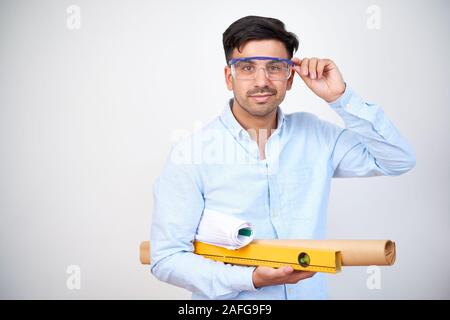 Smiling professional civil engineer putting on protective mask before visiting construction site Stock Photo