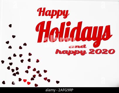 happy holidays lettering in frame with christmas decorations in red Stock Photo