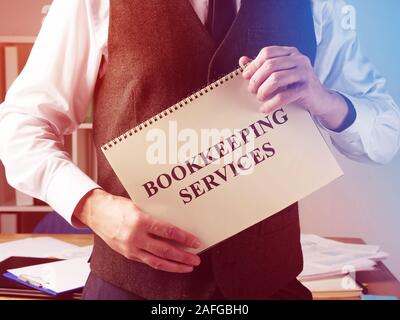 Bookkeeping services sign and accountant in the office. Stock Photo