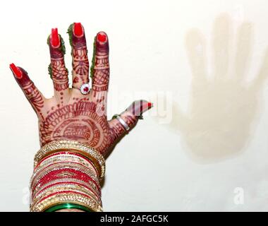 Indian bride hand print to cloth ritual ceremony Stock Photo