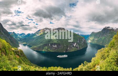 Geirangerfjord, Norway. Touristic Ship Ferry Boat Cruise Ship Liner Floating Near Geiranger In Geirangerfjorden In Summer Day. Famous Norwegian Landma Stock Photo