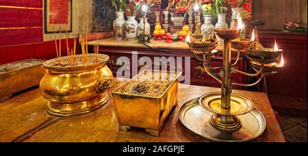 Incense urns an burning oil lamp in front of altar in Man Mo Temple. Sheung Wan, Hong Kong, China. Stock Photo