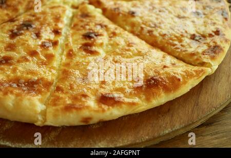 Closeup Fresh Baked Cheese-filled Georgian Flatbread Khachapuri Imeruli (Imeretian) on Wooden Plate Stock Photo