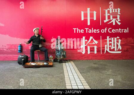 Street musician plays Erhu, traditional Chinese musical instrument. Central, Hong Kong, China. Stock Photo