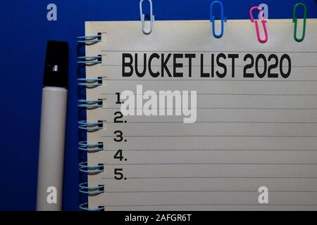 Bucket List 2020 write on book isolated on wooden table. Medical or Finance concept Stock Photo