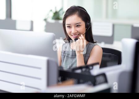 Young woman working in call center Stock Photo