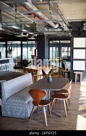 The eating and casual meeting area at a creative office in daylight, no people, vertical Stock Photo
