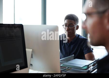 Two male colleagues  working in a creative office, close up, selective focus Stock Photo