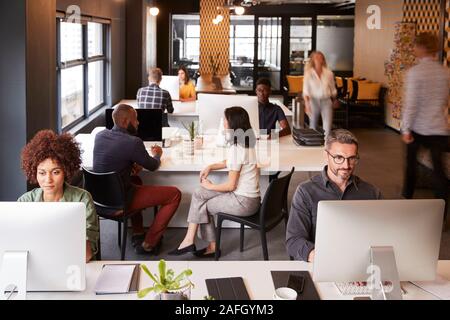 Elevated view of creative business colleagues working in a busy office Stock Photo