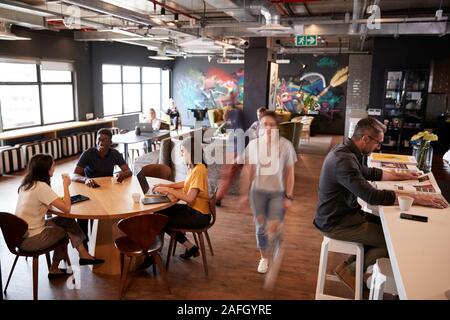 Creatives working and relaxing in their office canteen area Stock Photo