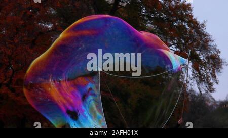 Closeup of soap bubbles in a garden with greenery on a blurry background Stock Photo