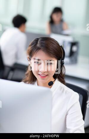 Young call center agents working in office Stock Photo
