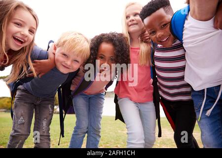 Portrait Of Excited Elementary School Pupils On Playing Field At Break Time Stock Photo