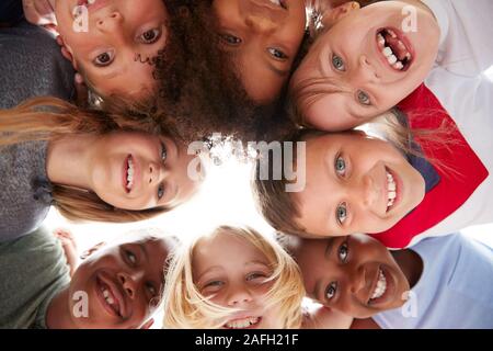 Group Of Multi-Cultural Children With Friends Looking Down Into Camera Stock Photo