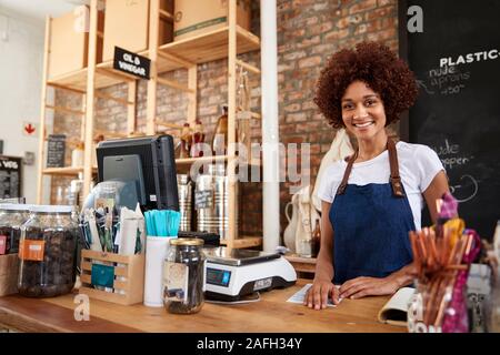 Portrait Of Female Owner Of Sustainable Plastic Free Grocery Store Behind Sales Desk Stock Photo