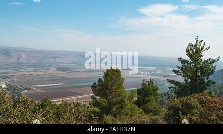 Hula Lake Park on the left and the hula nature reserve on the right from near the reut museum with trees in the foreground and the golan heights in th Stock Photo