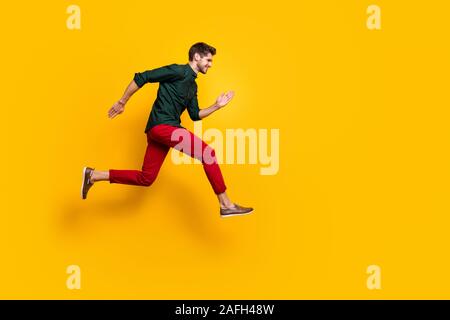 Full body profile side photo of positive cheerful funky guy hear about wonderful black friday sales jump run want be first wear casual style outfit Stock Photo