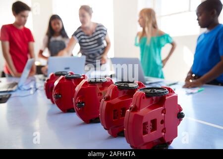Group Of Students In After School Computer Coding Class Learning To Program Robot Vehicle Stock Photo