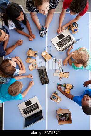 Overhead View Of Students In After School Computer Coding Class Learning To Program Robot Vehicle Stock Photo