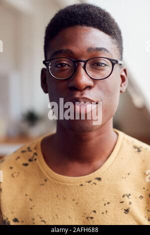 Portrait Of Young Man Wearing Glasses In Loft Apartment Stock Photo