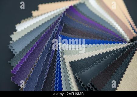A catalog with samples of genuine leather materials in different colors for the manufacture of designer clothes, shoes and accessories. Stock Photo