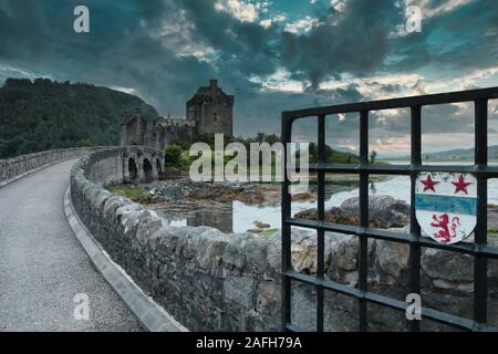 Clan MacRae family crest on gate to footbridge leading to Eilean Donan Castle, Western Highlands, Scotland