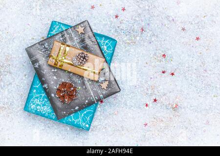Top view or flat lay picture of wrapped gifts with decoration on fake snow with copy or empty space for text. Christmas holiday concept. Stock Photo