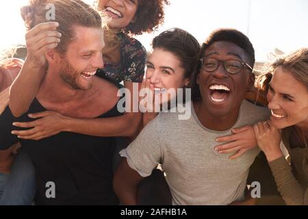 Smiling Young Friends Walking Outdoors Together Stock Photo