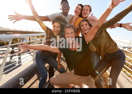 Portrait Of Young Friends Outdoors Posing On Gangway Together Stock Photo