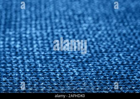 Blurred abstract background of trendy blue knitted fabric. Flat lay. Top view. Mockup for your design. Color of the year 2020 concept. Trendy blue bac Stock Photo