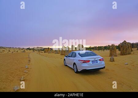CERVANTES, AUSTRALIA -9 JUL 2019- View of a Toyota Camry car rented from Hertz in the Pinnacles Desert in Nambung National Park, Cervantes, Western Au Stock Photo