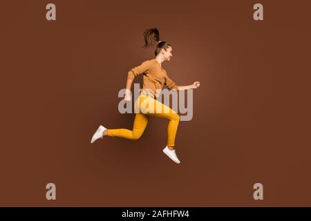 Full length body size photo of cheerful positive cute nice charming sweet pretty sporty girlfriend hurrying to come to finish on time wearing yellow Stock Photo