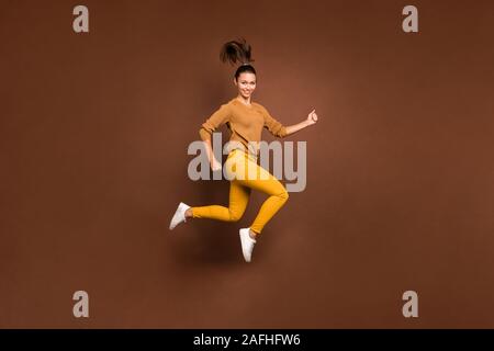 Full length body size photo of cheerful cute nice charming sweet pretty girlfriend youngster jumping up running towards shopping mall for sales Stock Photo