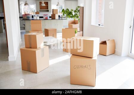Stacked Removal Boxes In Empty Room On Moving Day