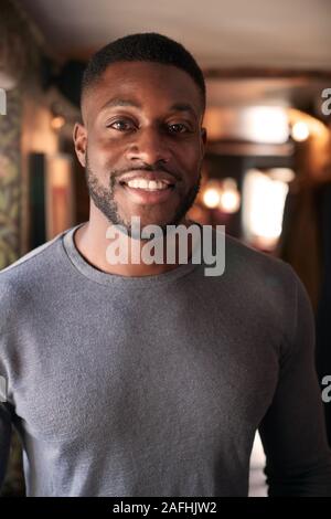 Portrait Of Smiling Male Receptionist Working  At Hotel Check In Stock Photo