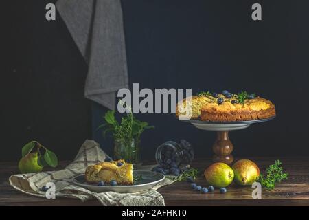 Delicious dessert blueberry tart with fresh berries and pears, sweet tasty cheesecake, berry pie. French cuisine Artistic Still Life in the style of D Stock Photo